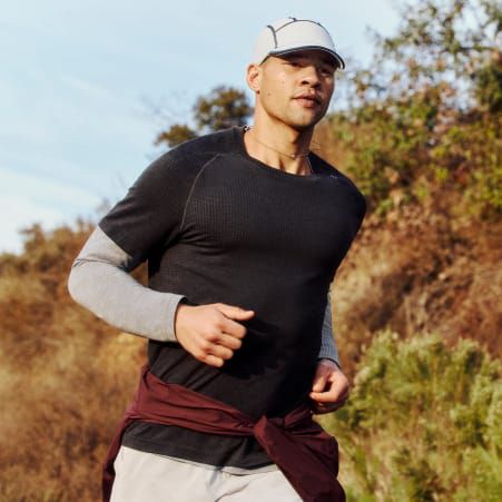 Man dressed in lululemon casualwear with a city background.