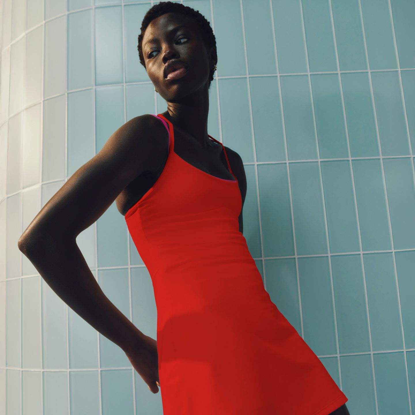 A person wearing the Flow Y Dress Light Support, B/C Cup in Cherry Ember.