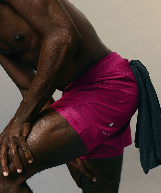 A person wearing the Fast and Free Running Short 5” in Raspberry Rave.