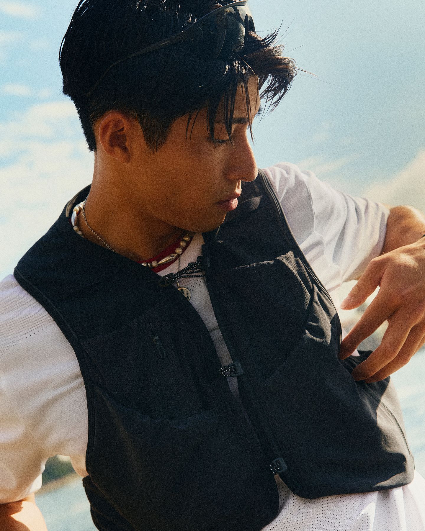 A person wearing a Fast and Free Short-Sleeve Shirt in White and a Fast and Free Running Vest in Black.