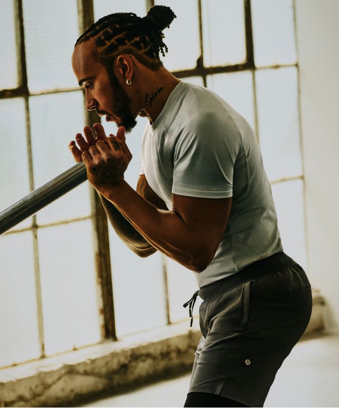 Seven-time world champion and lululemon Ambassador Lewis Hamilton exercises in Repper Short Sleeve Top and License to Train Short.