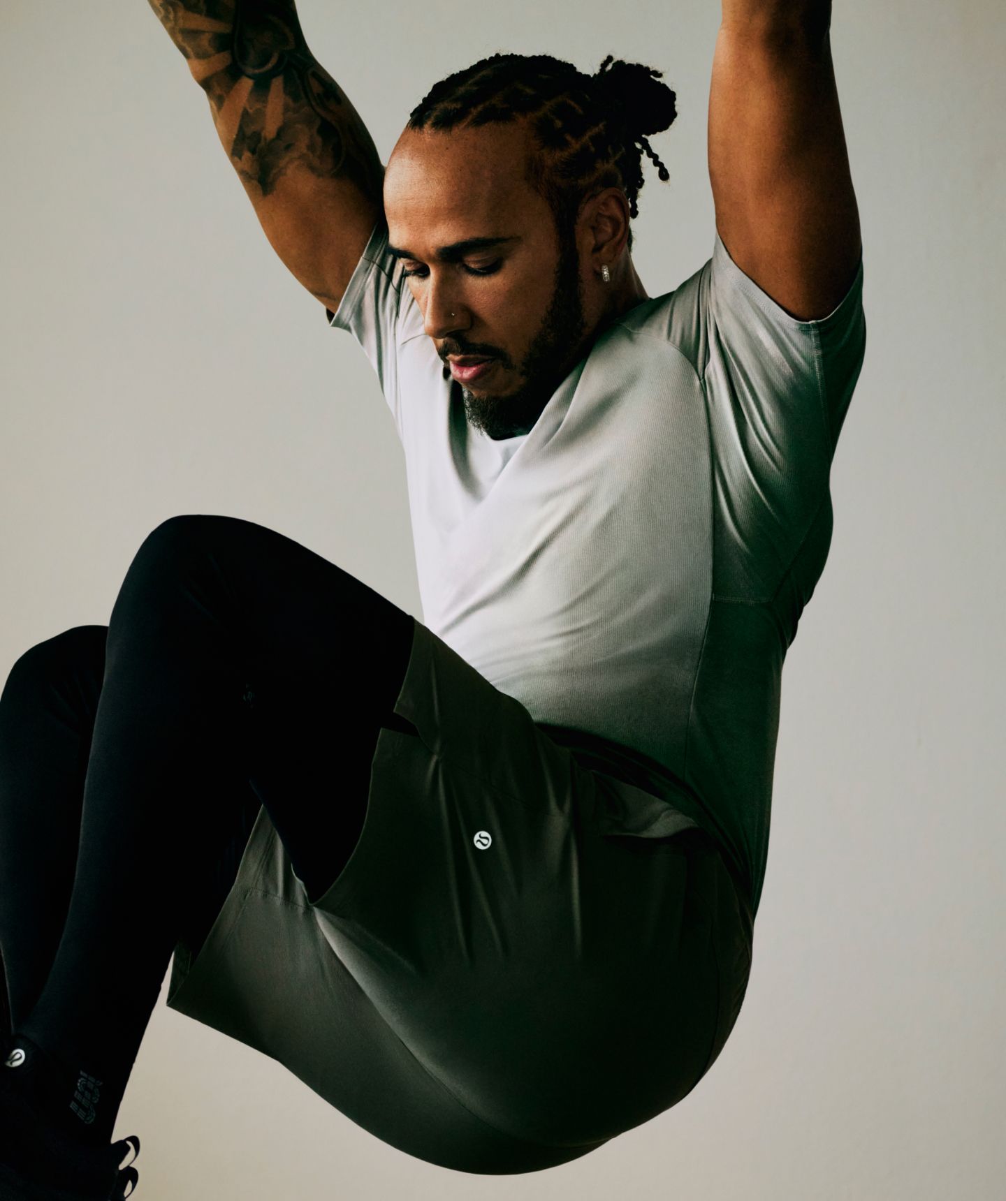 Seven-time world champion and lululemon Ambassador Lewis Hamilton exercises in Repper Short Sleeve Top and License to Train Short.