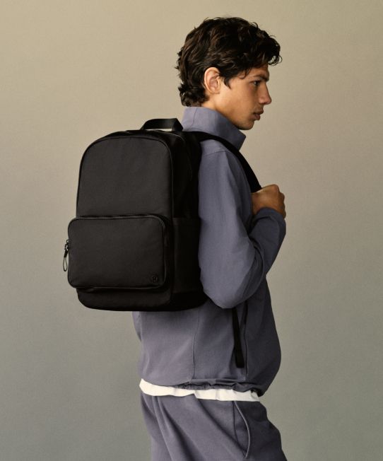 A person standing with a backpack on their back.