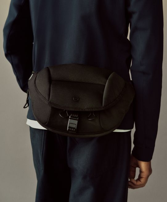 A close-up shot of a person's back and they are wearing the Daily Dispatch Belt Bag at their waist.
