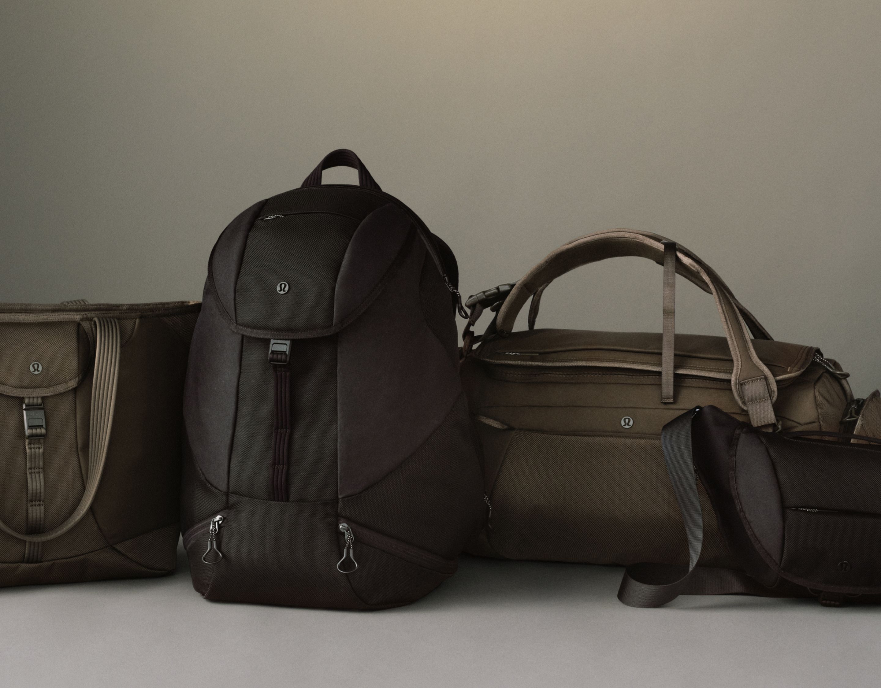Four backpacks are shown sitting next to eachother: Everywhere Backpack, Daily Dispatch Backpacks. and New Crew Backpack.