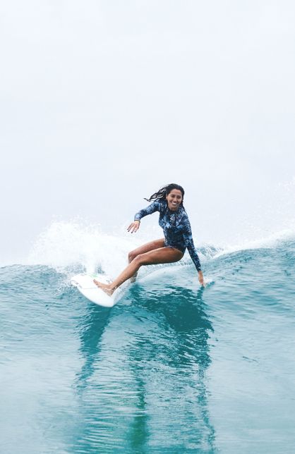 Woman having fun surfing on wave in the ocean