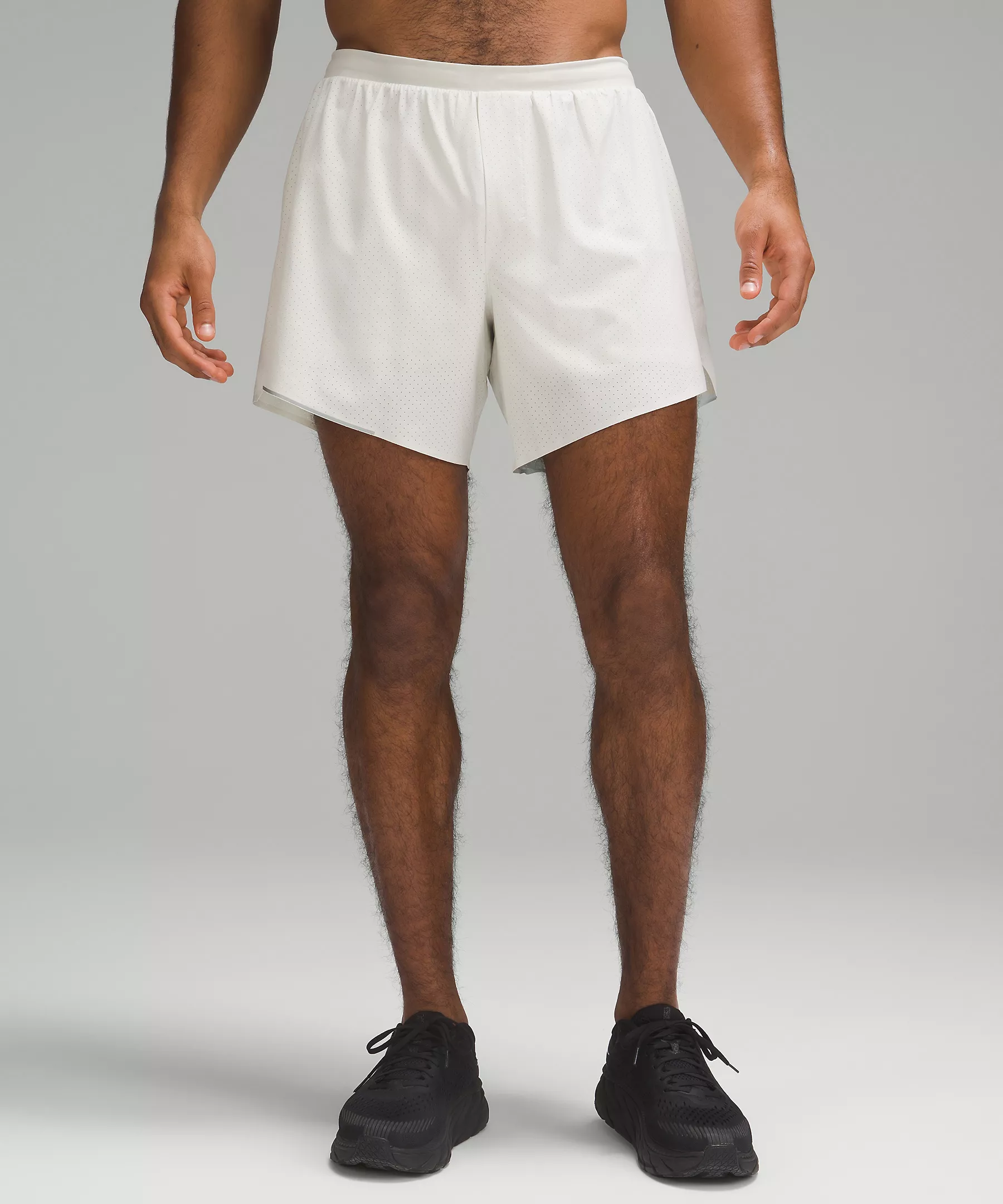 A close up photo of a man wearing the white lulu lemon sport shorts