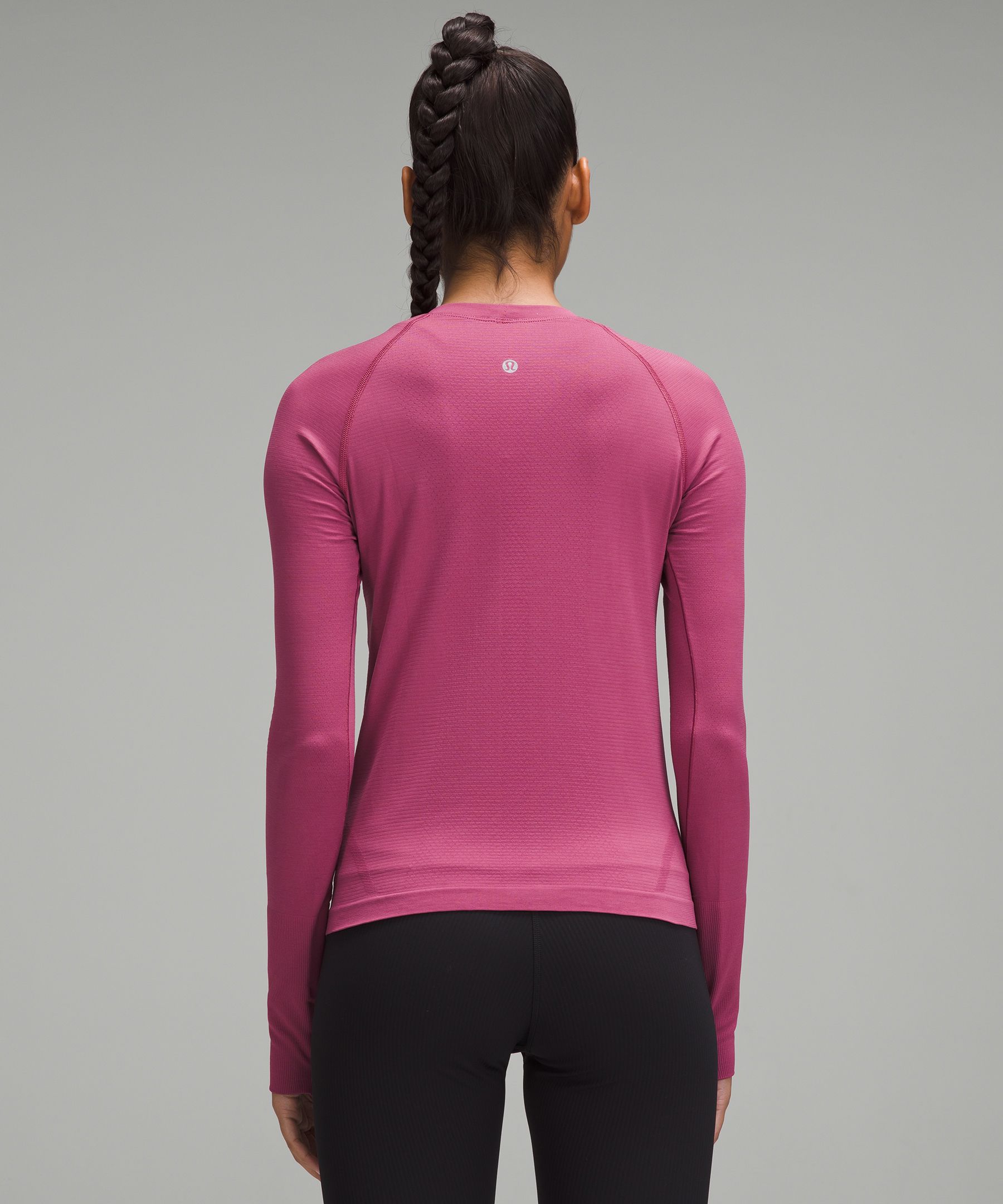 Woman in Pink Long Sleeve Shirt and Pink Leggings Riding on Green