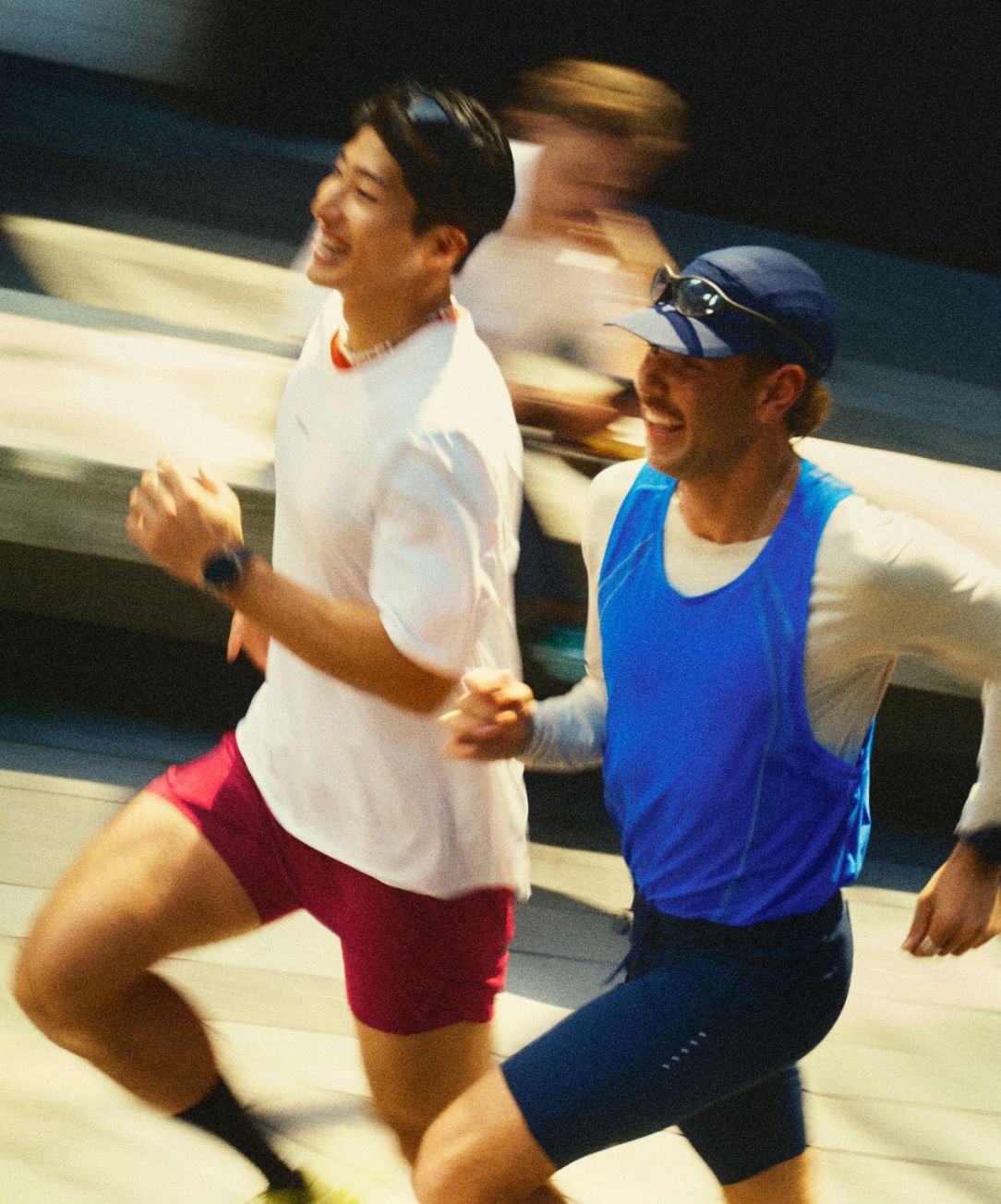 Two people wear lululemon Fast and Free™ running gear through the city. 