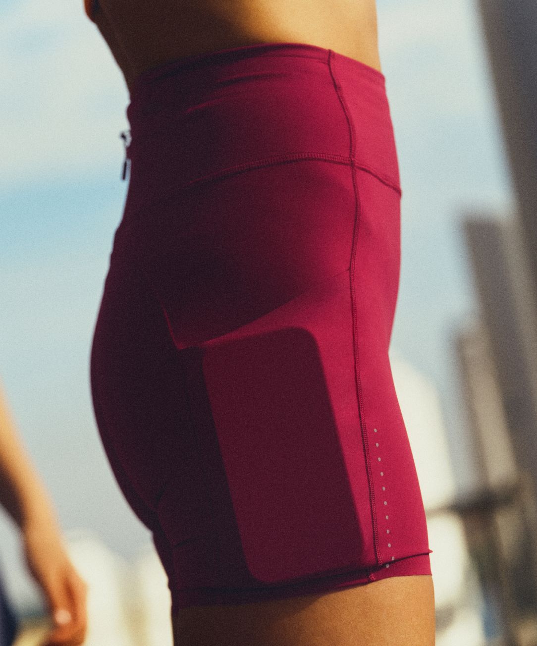 A person wears the lululemon Fast and Free™ High-Rise Short, showing a phone tucked into the low-bounce side pocket. 