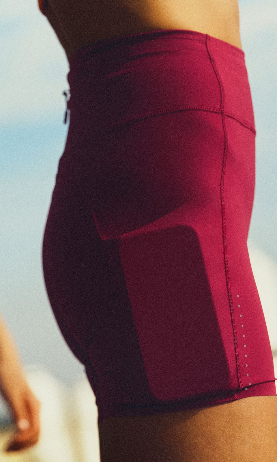 A person wears the lululemon Fast and Free™ High-Rise Short, showing a phone tucked into the low-bounce side pocket. 