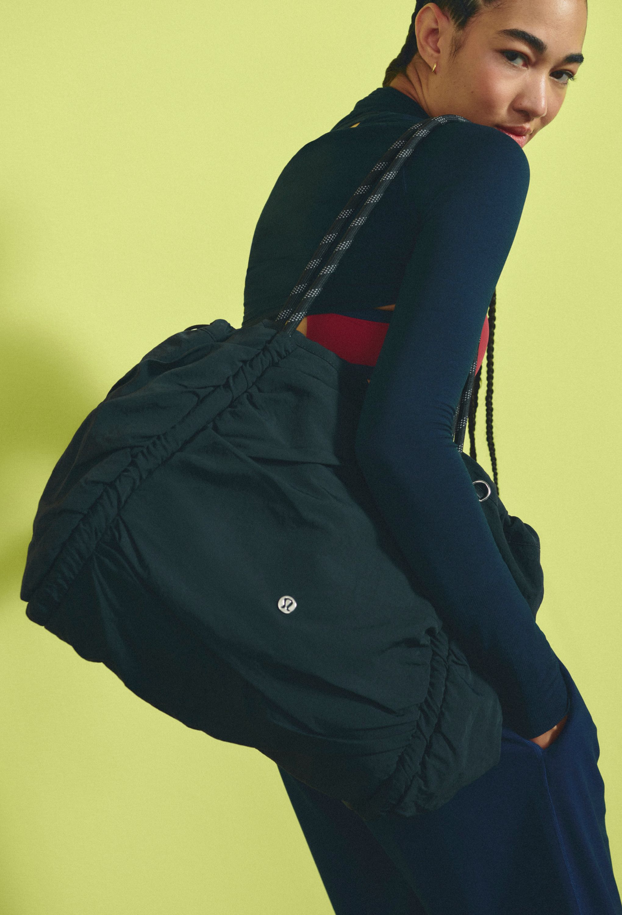 A person carries the lululemon Ruched Tote Bag.