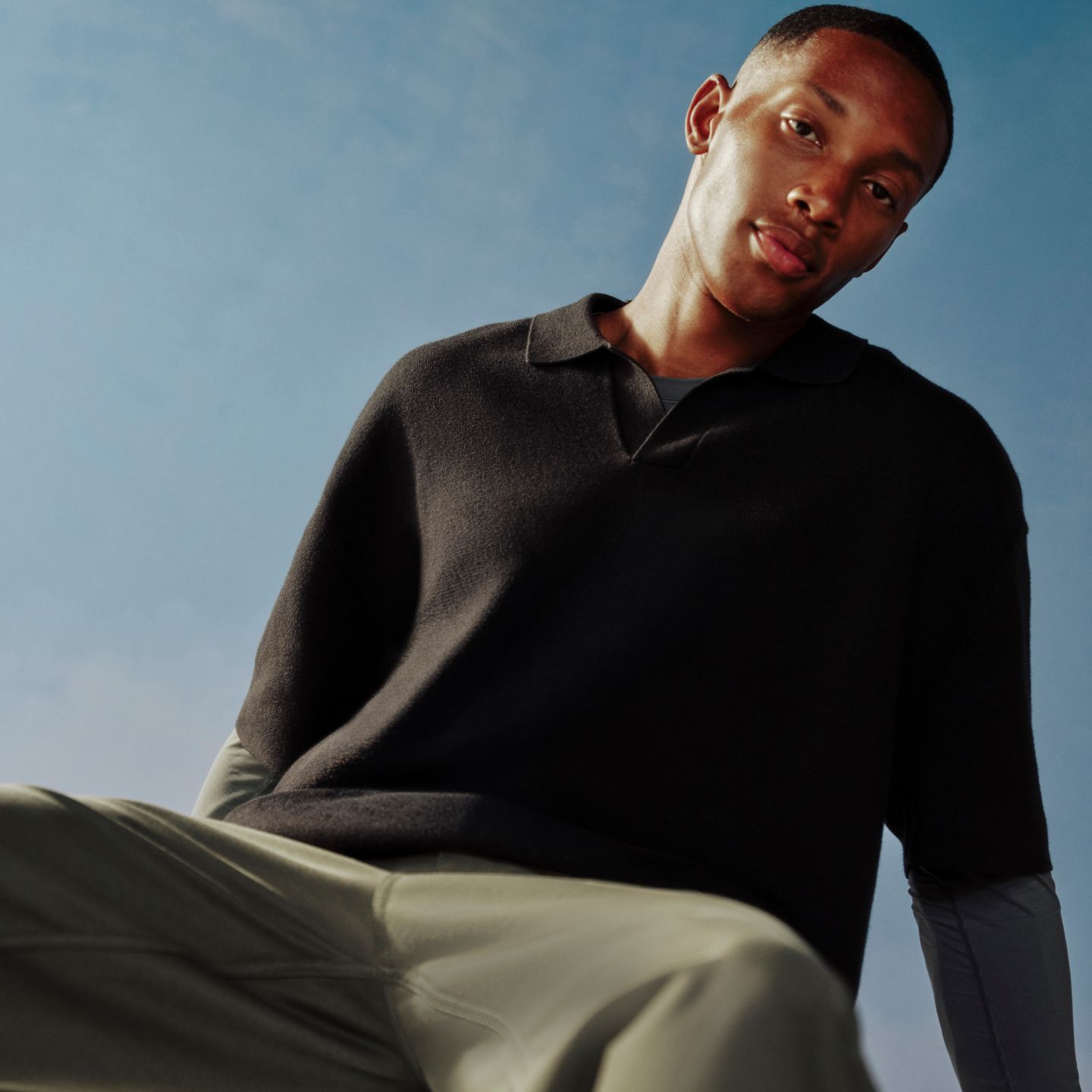 A person is wearing the Cotton-Blend Knit Short-Sleeve Polo Shirt.