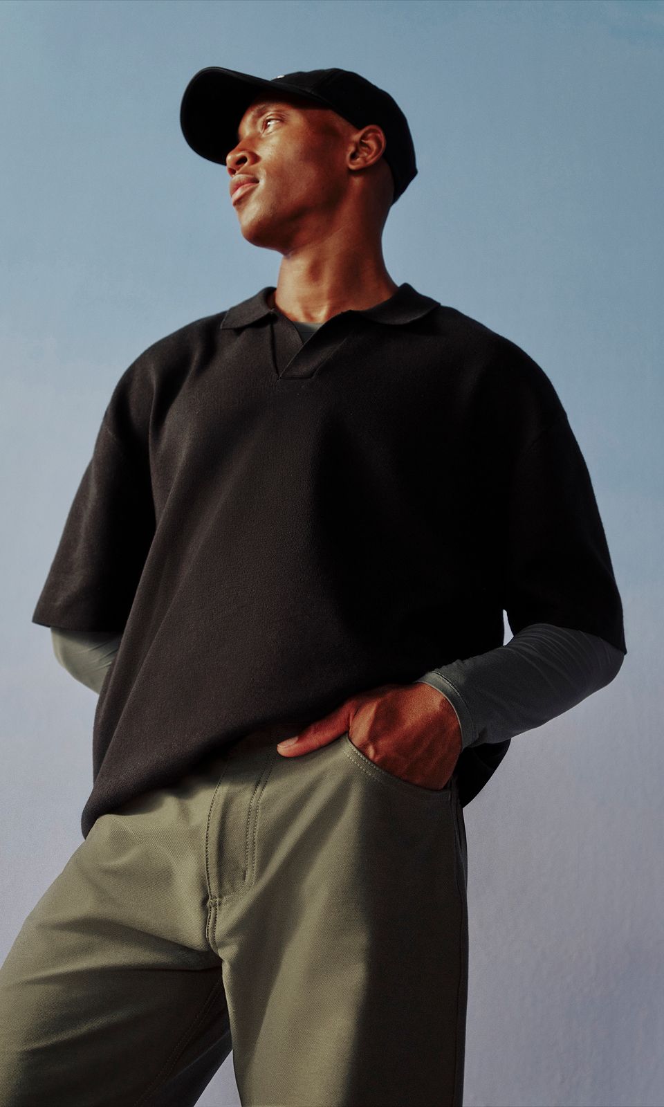 A person is wearing the Cotton-Blend Knit Short-Sleeve Polo Shirt.