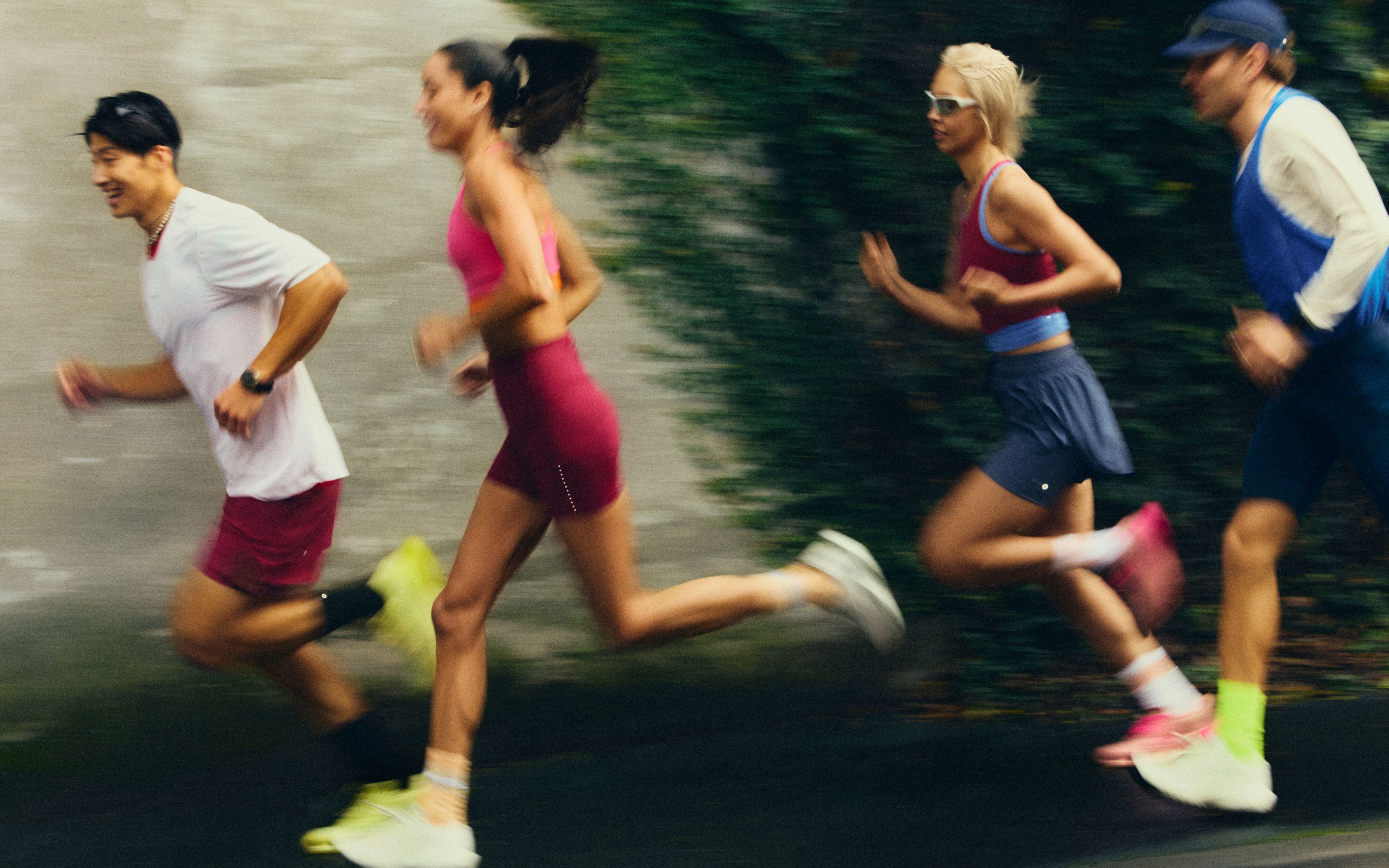 A blurred image of people running outside in lululemon gear.