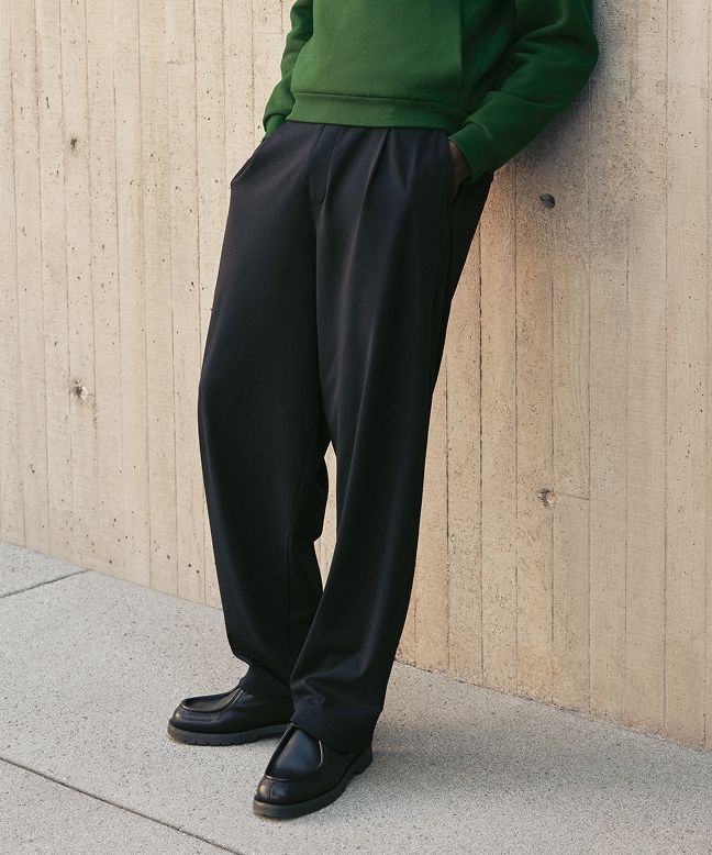 A person wears the Steady State Pullover Hoodie and Daydrift Relaxed Pleated Trouser.