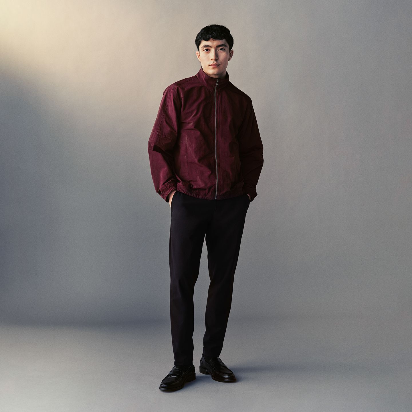 A person wears the Nylon Windbreaker and ABC Slim-Fit Trouser 34L in Warpstreme. 
