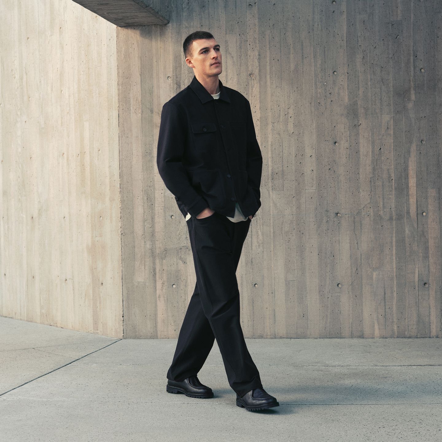A person wears the EasyFive Loose Straight Pant 34L, Utilitech Twill Chore Coat, and Heavyweight Cotton Jersey T-Shirt.