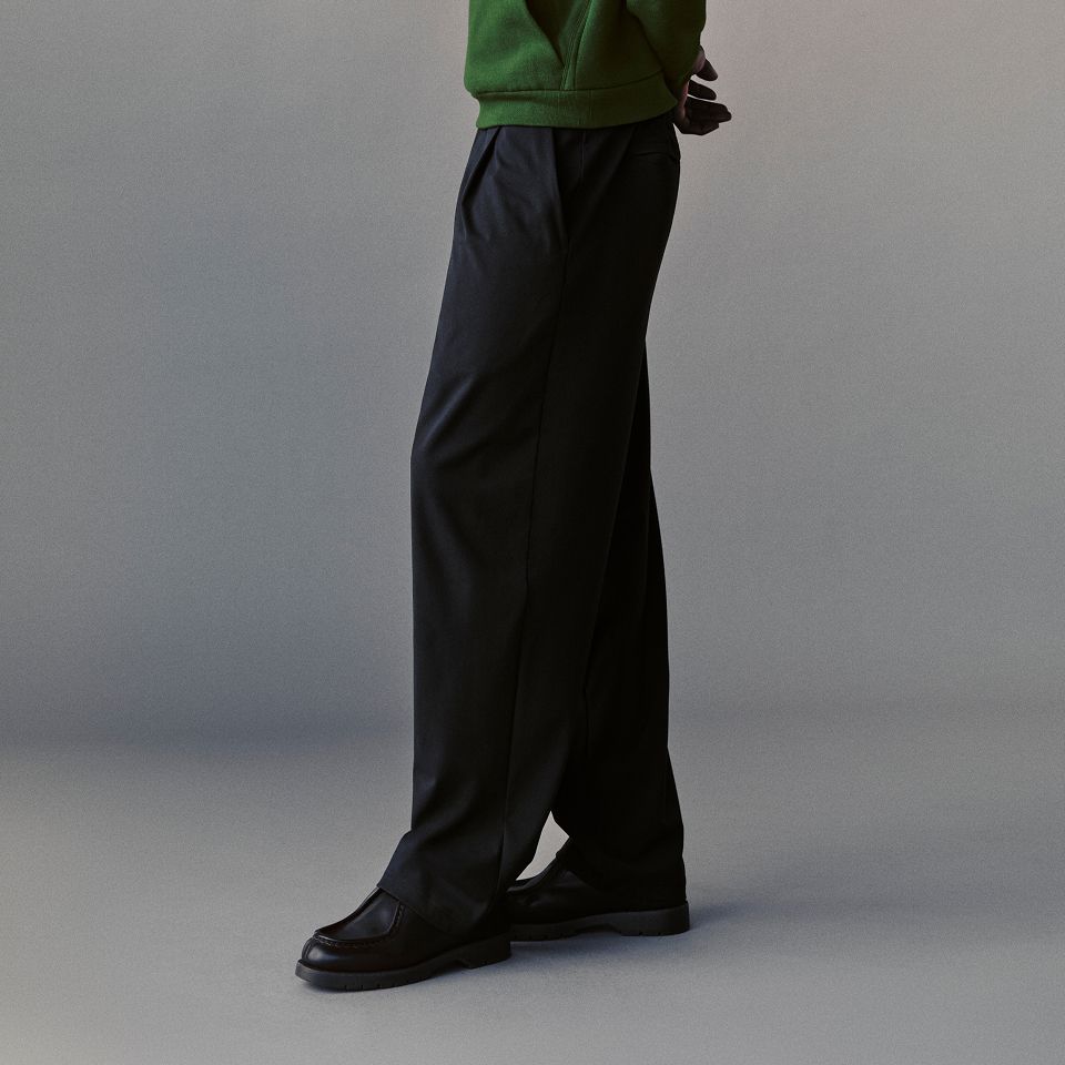 A person wears the Steady State Pullover Hoodie and Daydrift Relaxed Pleated Trouser.