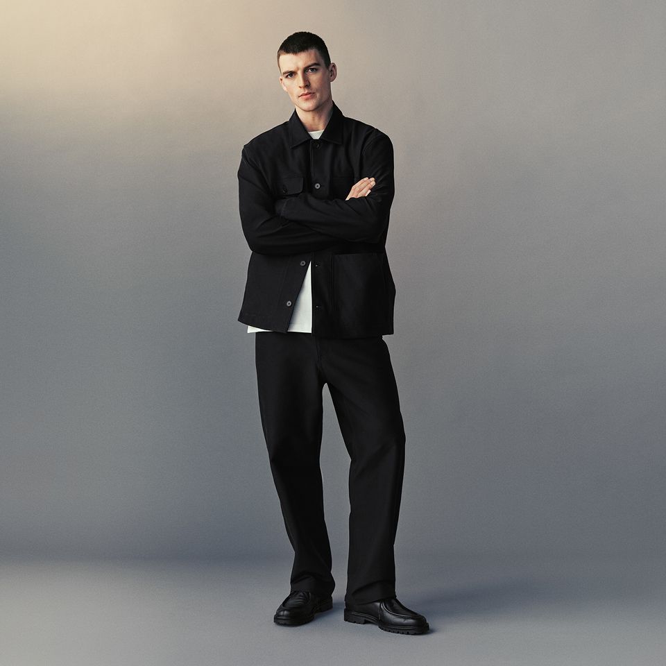 A person wears the EasyFive Loose Straight Pant 34L, Utilitech Twill Chore Coat, and Heavyweight Cotton Jersey T-Shirt.
