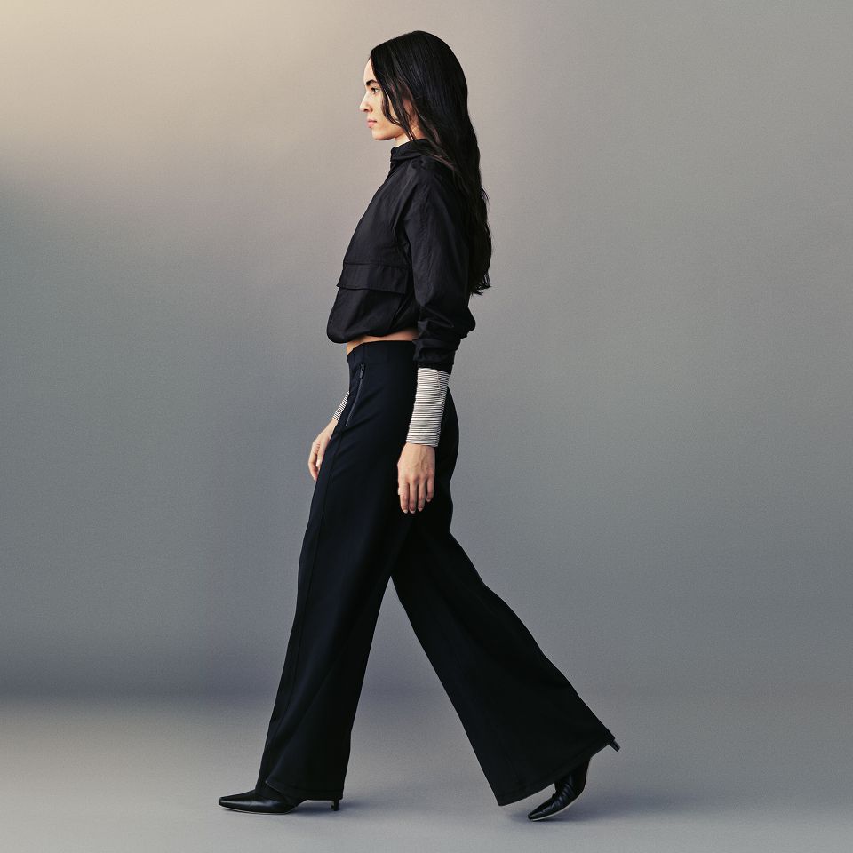 A person wears the Hood Lite Jacket, Define High-Rise Wide-Leg Pant, and Hold Tight Straight Hem Cropped Long-Sleeve Shirt.