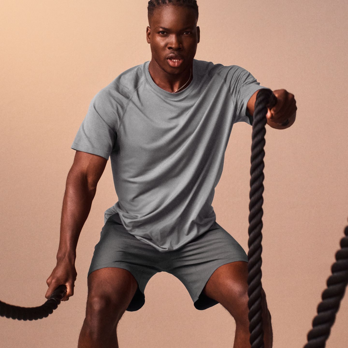 A person wears lululemon training gear for a high-intensity workout with heavy battle ropes.