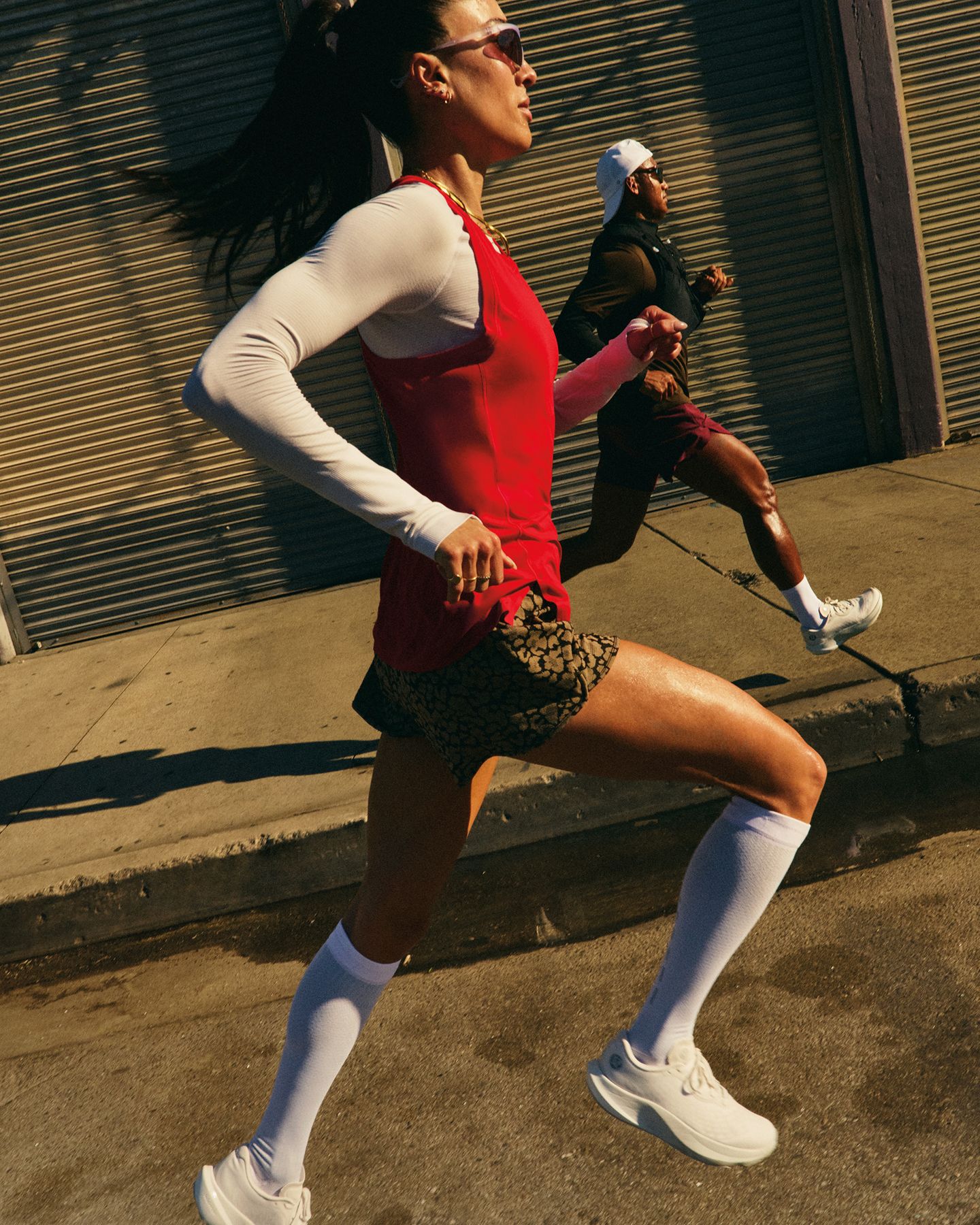 People in lululemon gear run on an urban street and sidewalk.