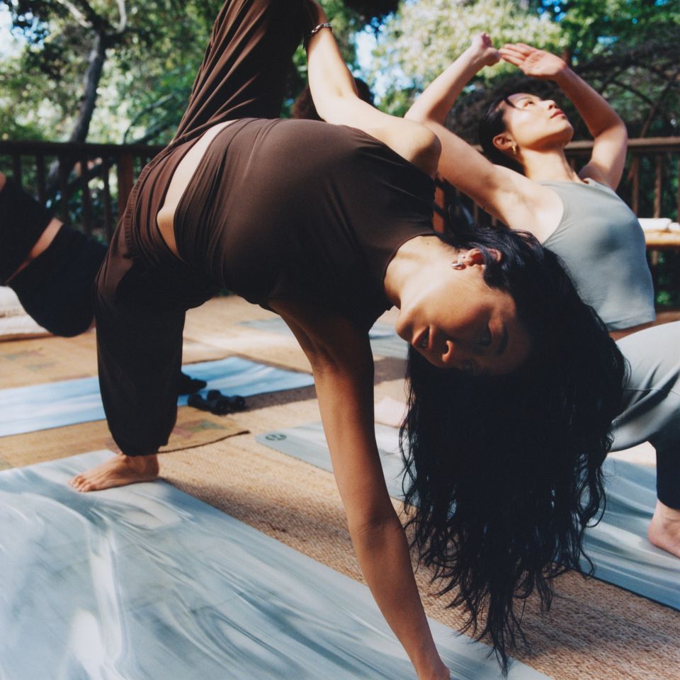  A person does yoga while wearing lululemon clothes.