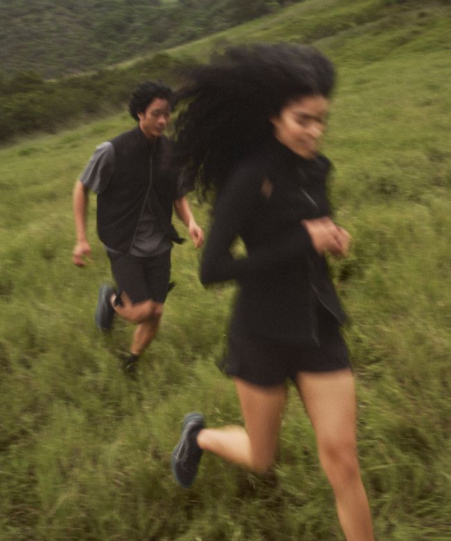 People in lululemon gear run on a hill.