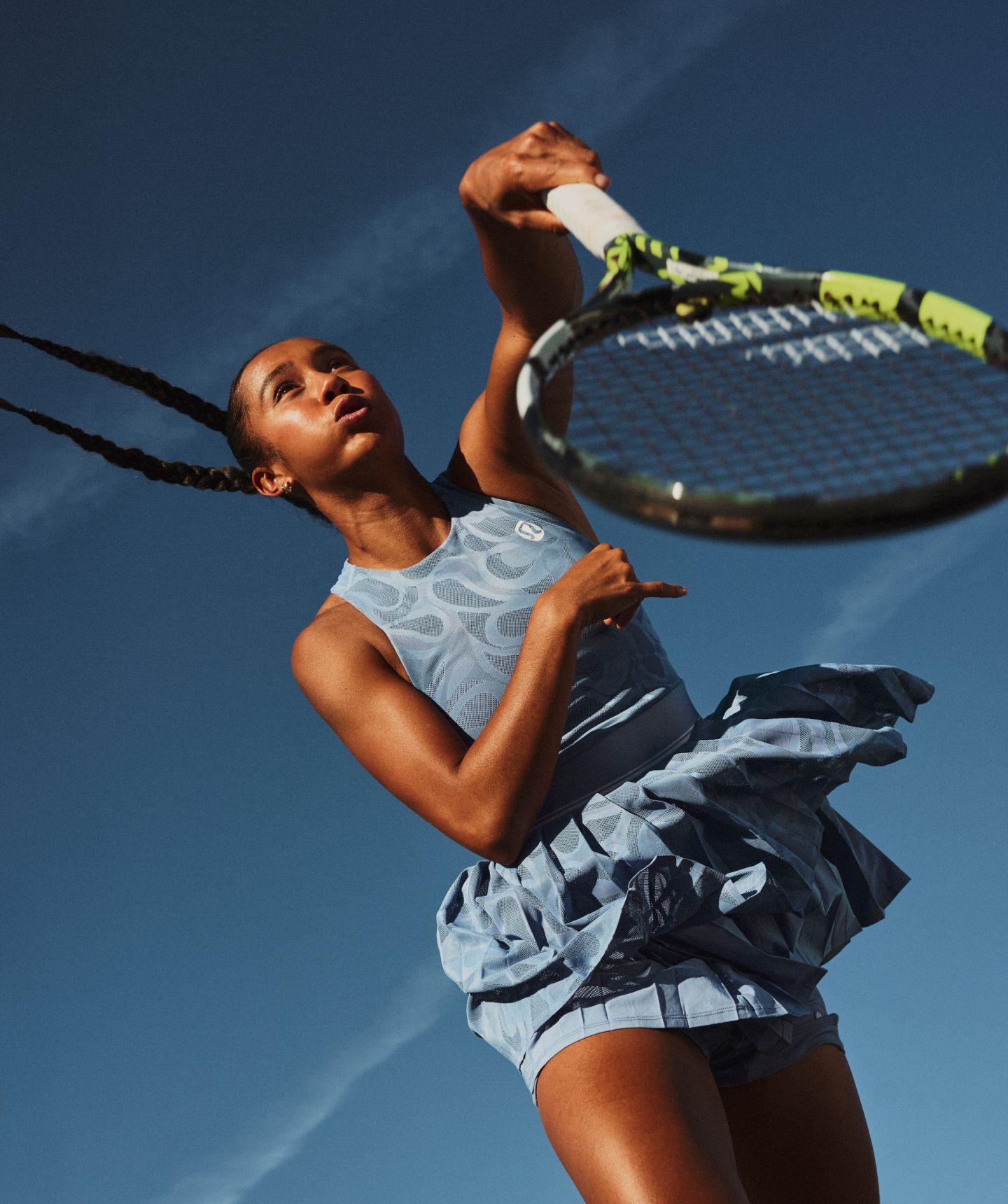 A person plays tennis in lululemon clothes.