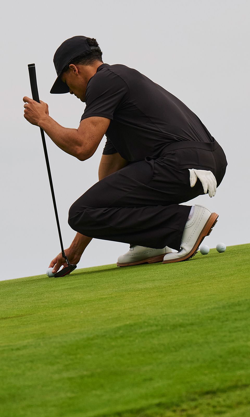 Seven-Time World Champion and lululemon Ambassador Lewis Hamilton wears the Grand Standard Short-Sleeve Polo and Unshaken Relaxed-Fit Pant from lululemon on a golf course.
