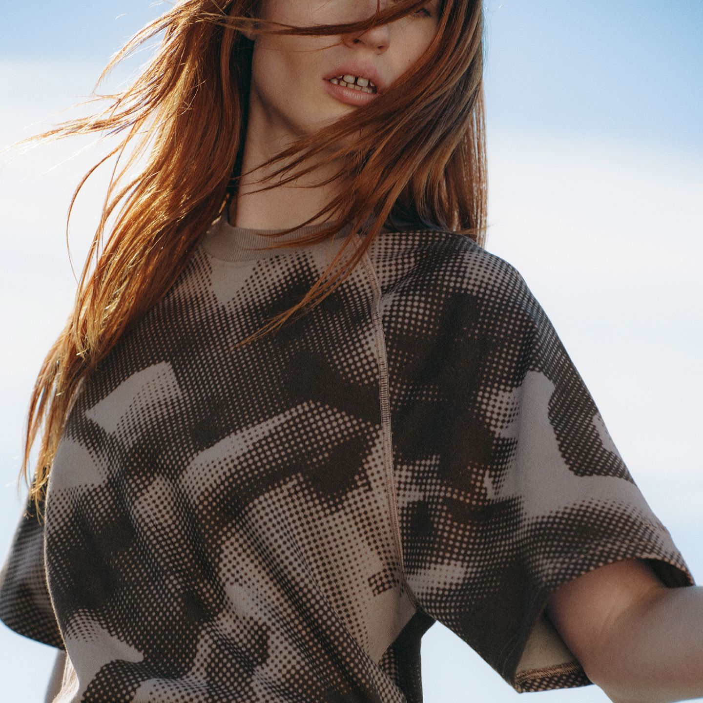 Close up shot of a person wearing clothes from the summer 2026 SLNSH collection.