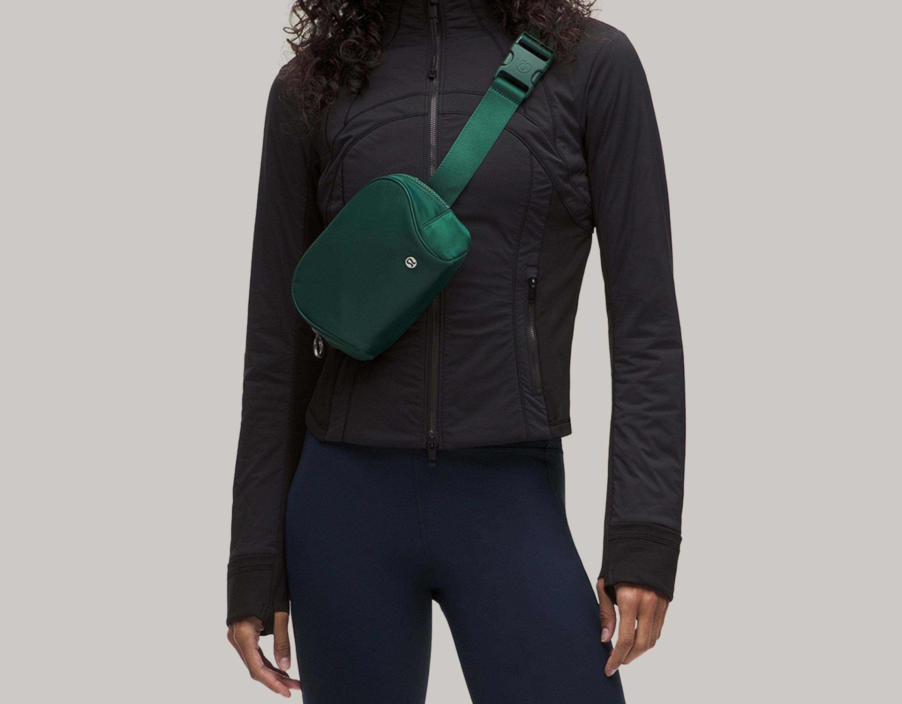 A person in a new Define Jacket with a new Everywhere Belt Bag. 