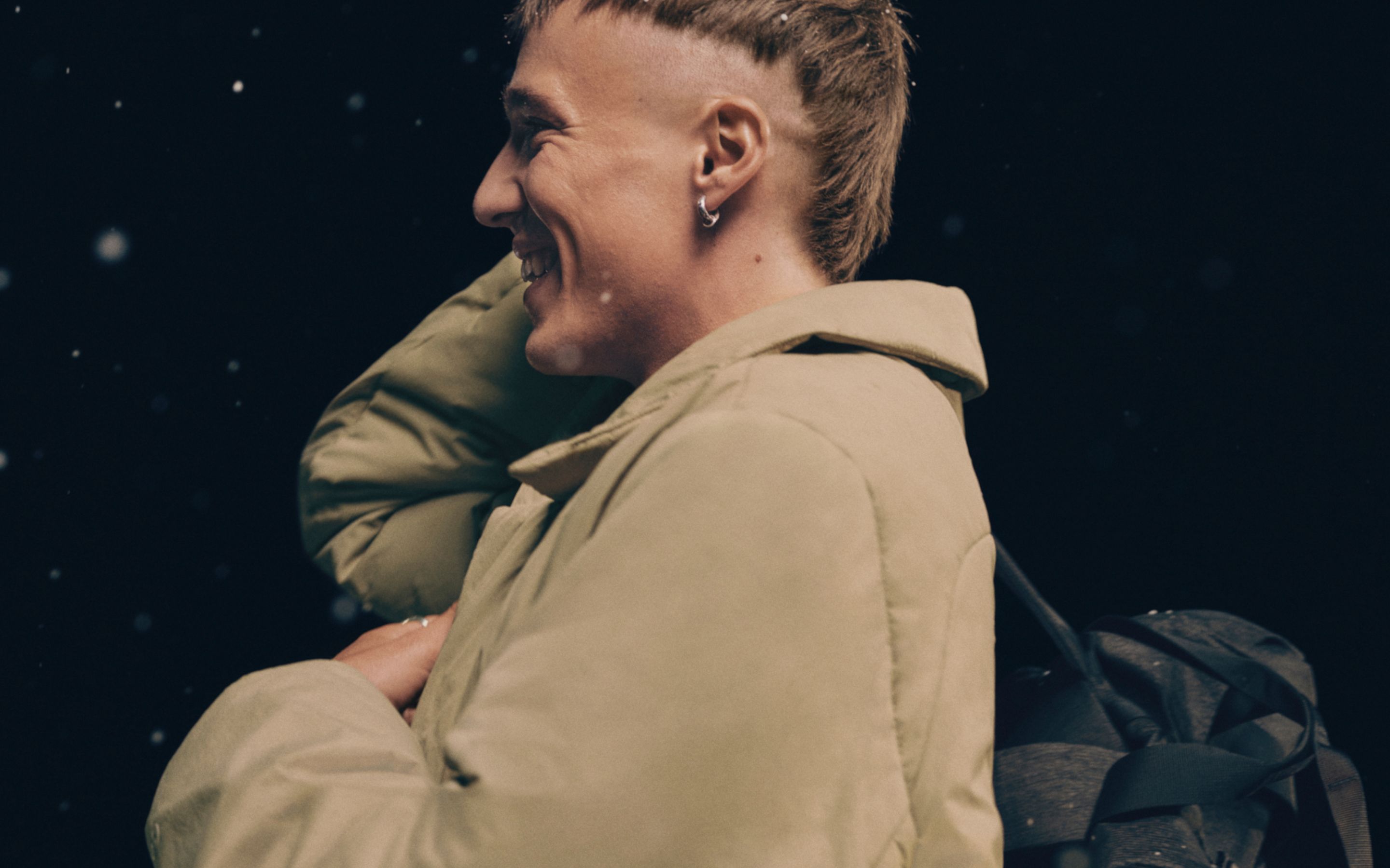 A person turned to the side wearing a ThermoZen jacket. 