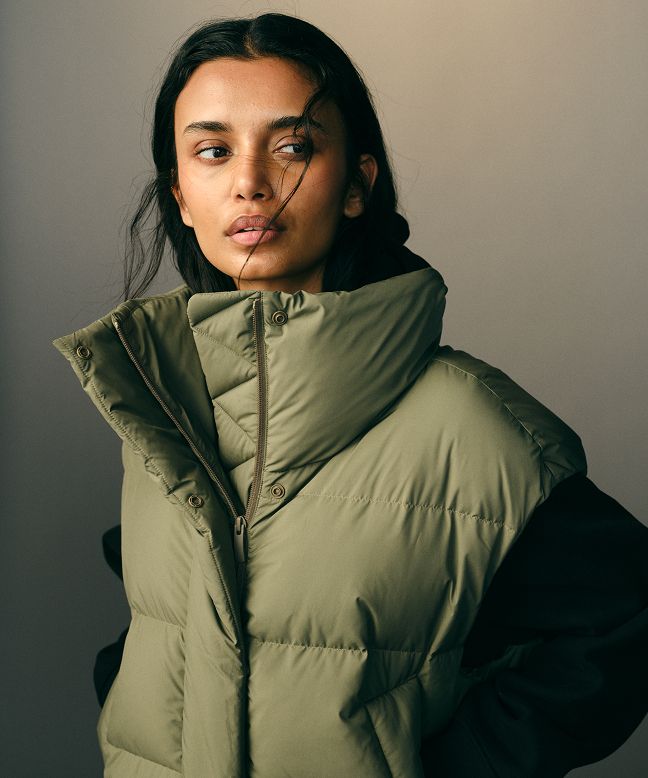 A person wearing the Wunder Puff Bomber Vest. 