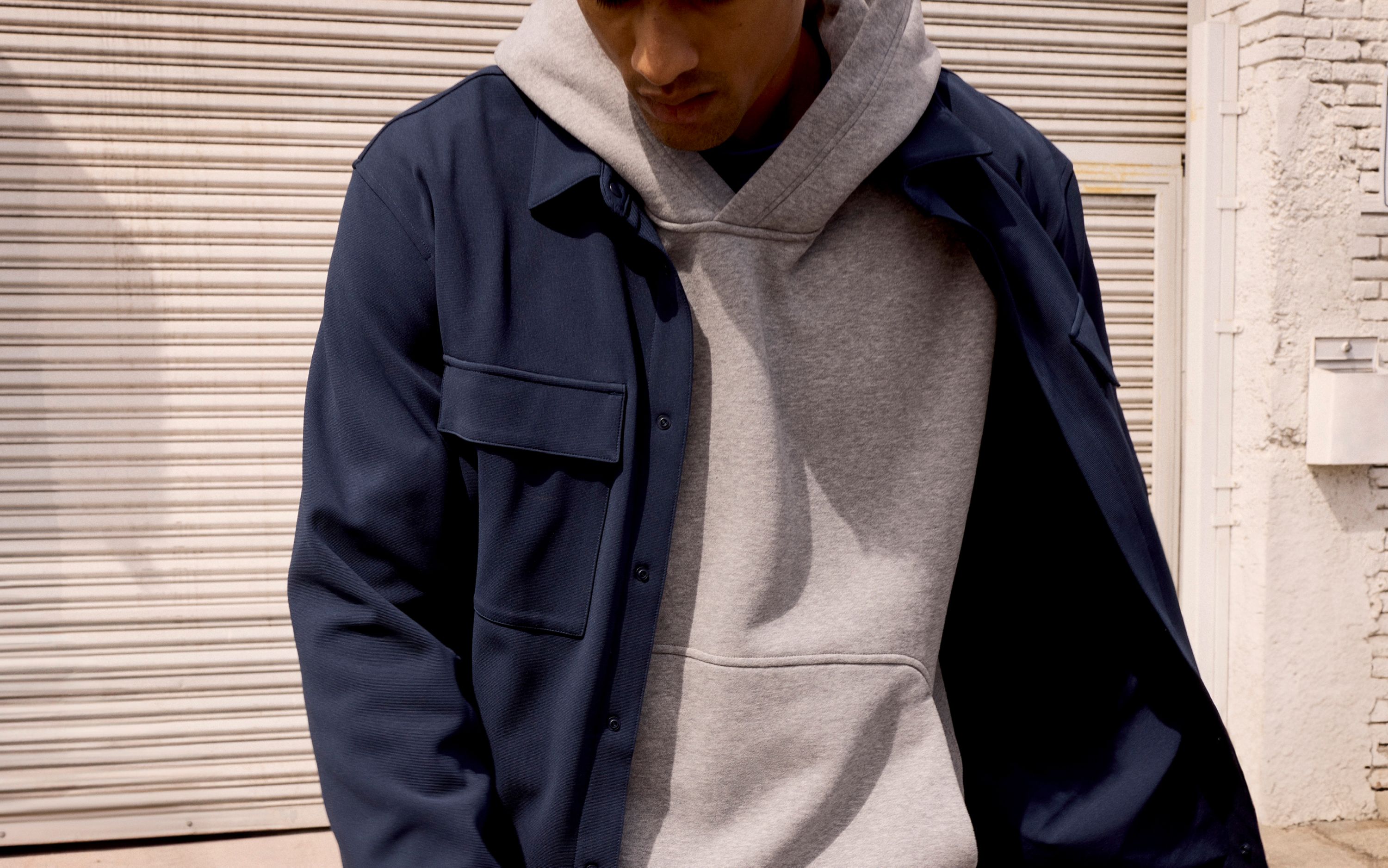 A person wears the lululemon Sojourn Overshirt and Steady State SuperLoft™ Pullover Hoodie.