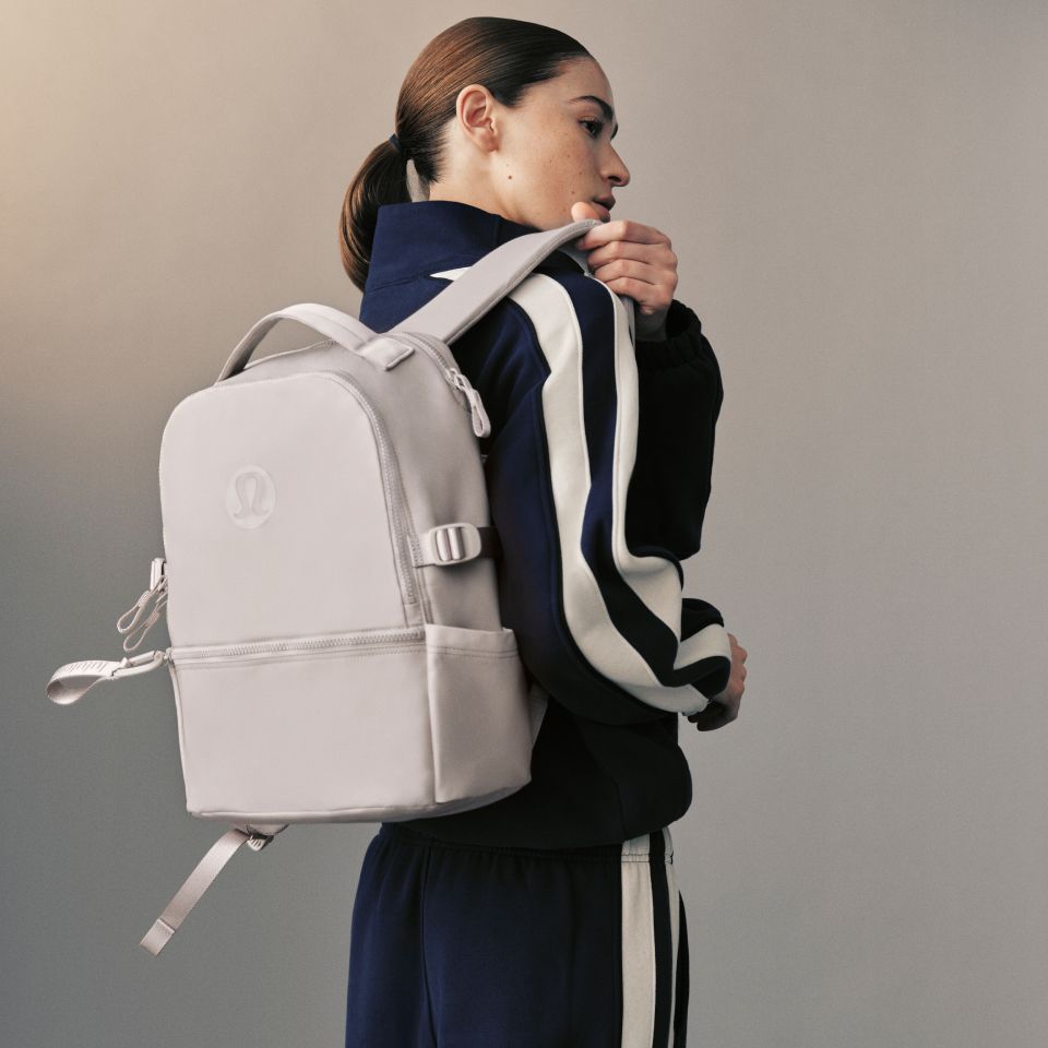 A person carries a New Crew backpack.