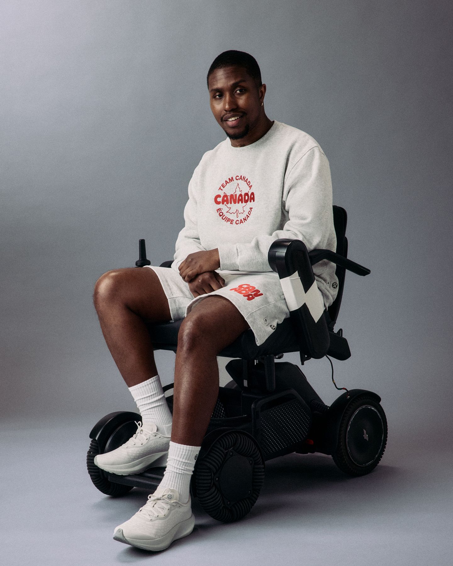 A para-athlete in a wheelchair is wearing the Team Canada Steady State Crew and Steady State Classic-Fit Short. 