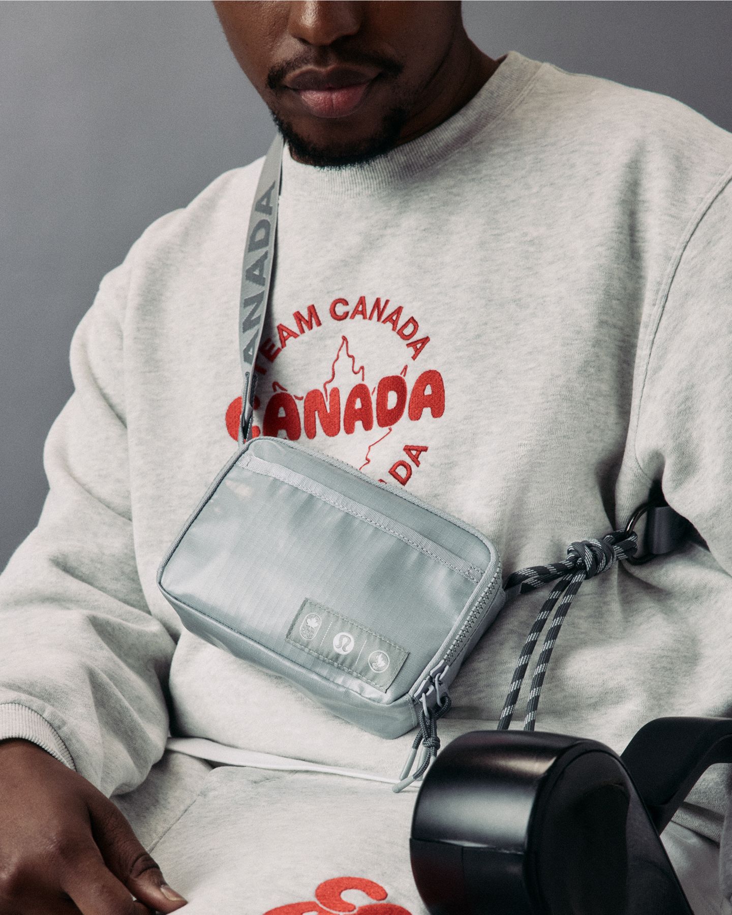 A close up of para-athlete in a wheelchair is wearing the Team Canada Steady State Crew, Steady State Classic-Fit Short and Future Legacy Easy Access Ripstop Crossbody Bag.
