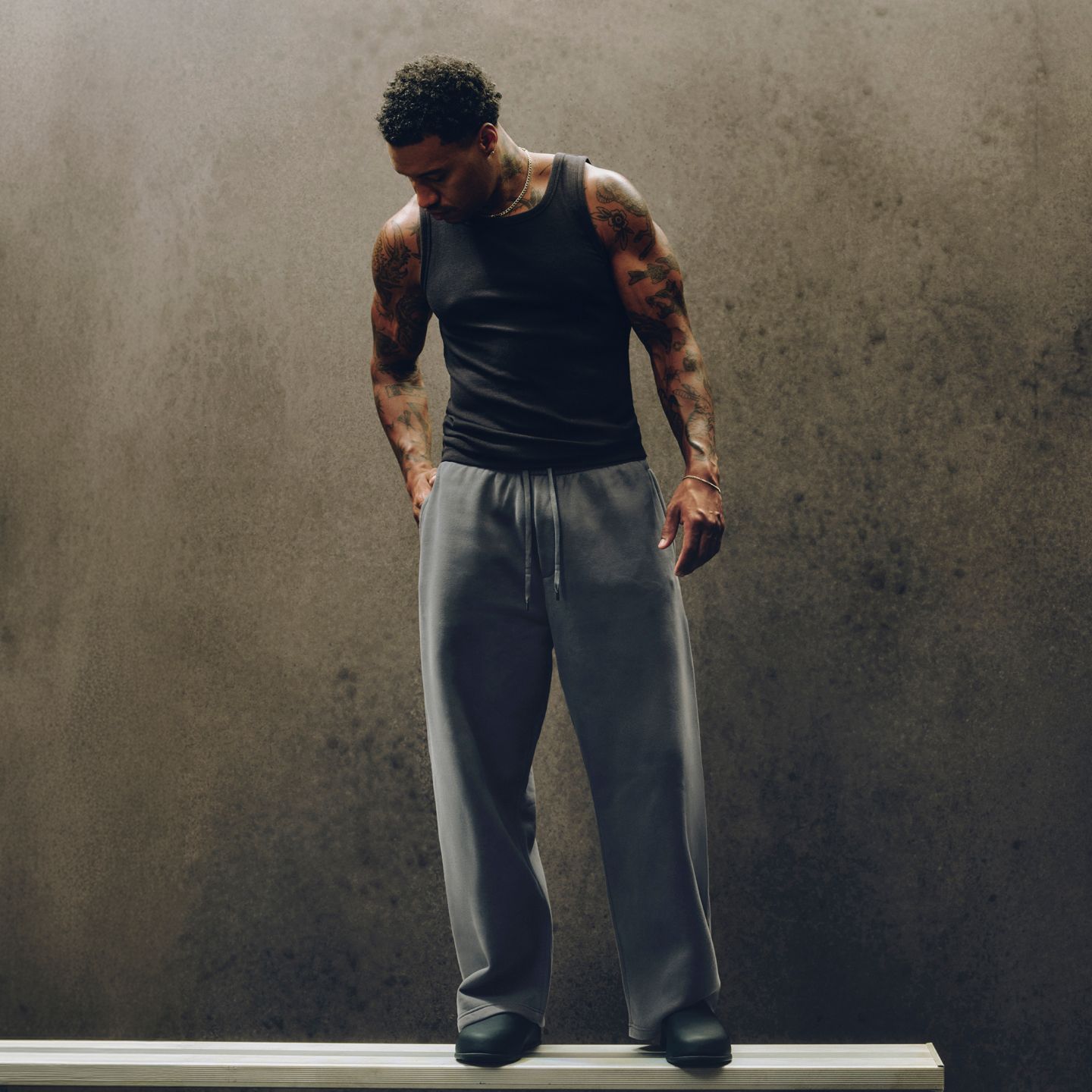 A person wears a new Steady State SuperLoft™ Pant for post-workout recovery.