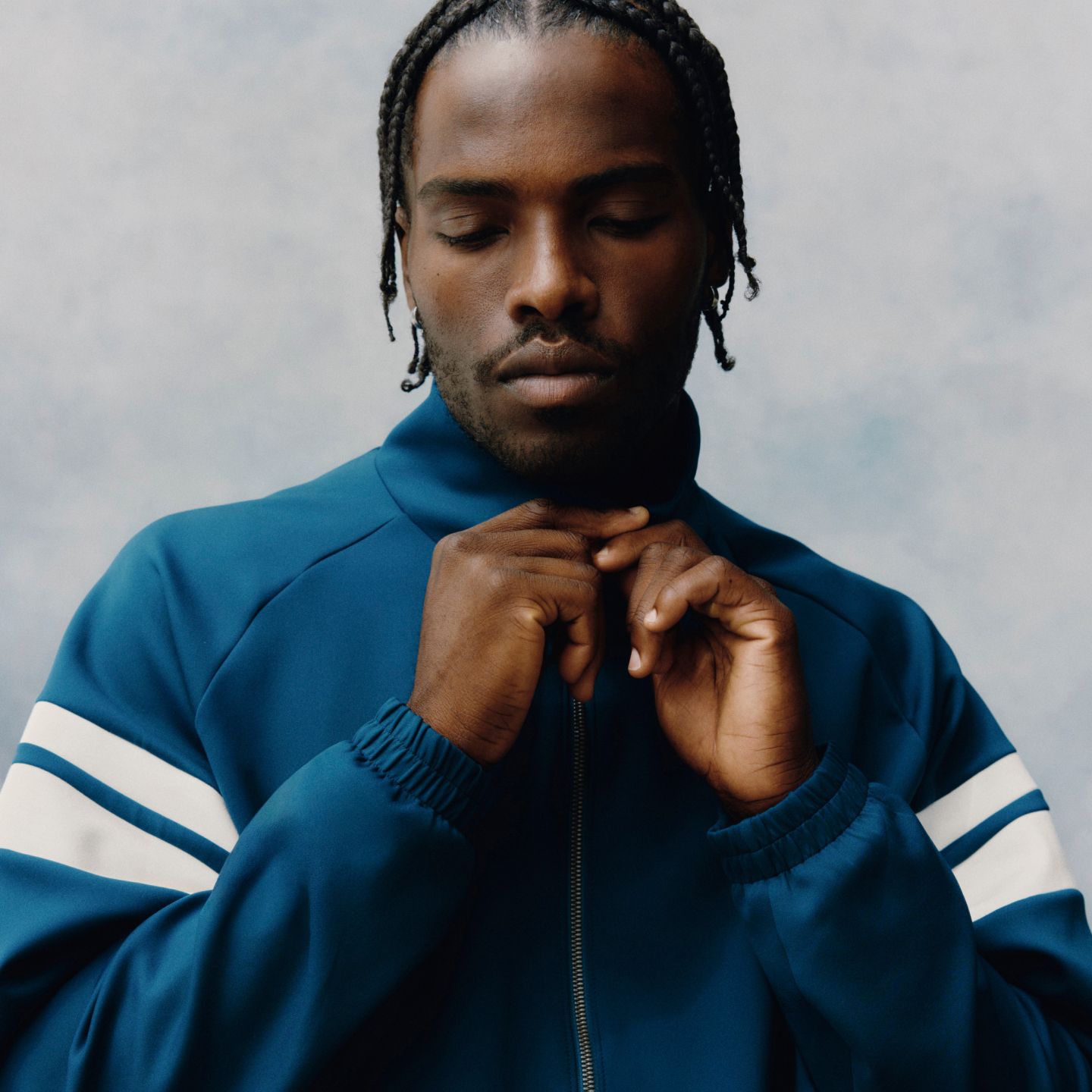 A person is wearing the Spacer Track Jacket. 