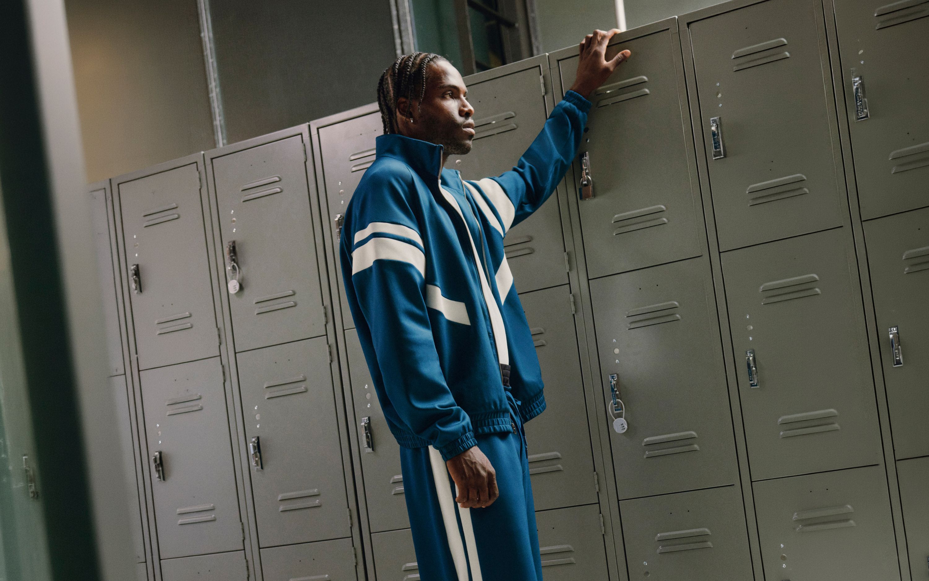 A person is wearing the Spacer Tracksuit.