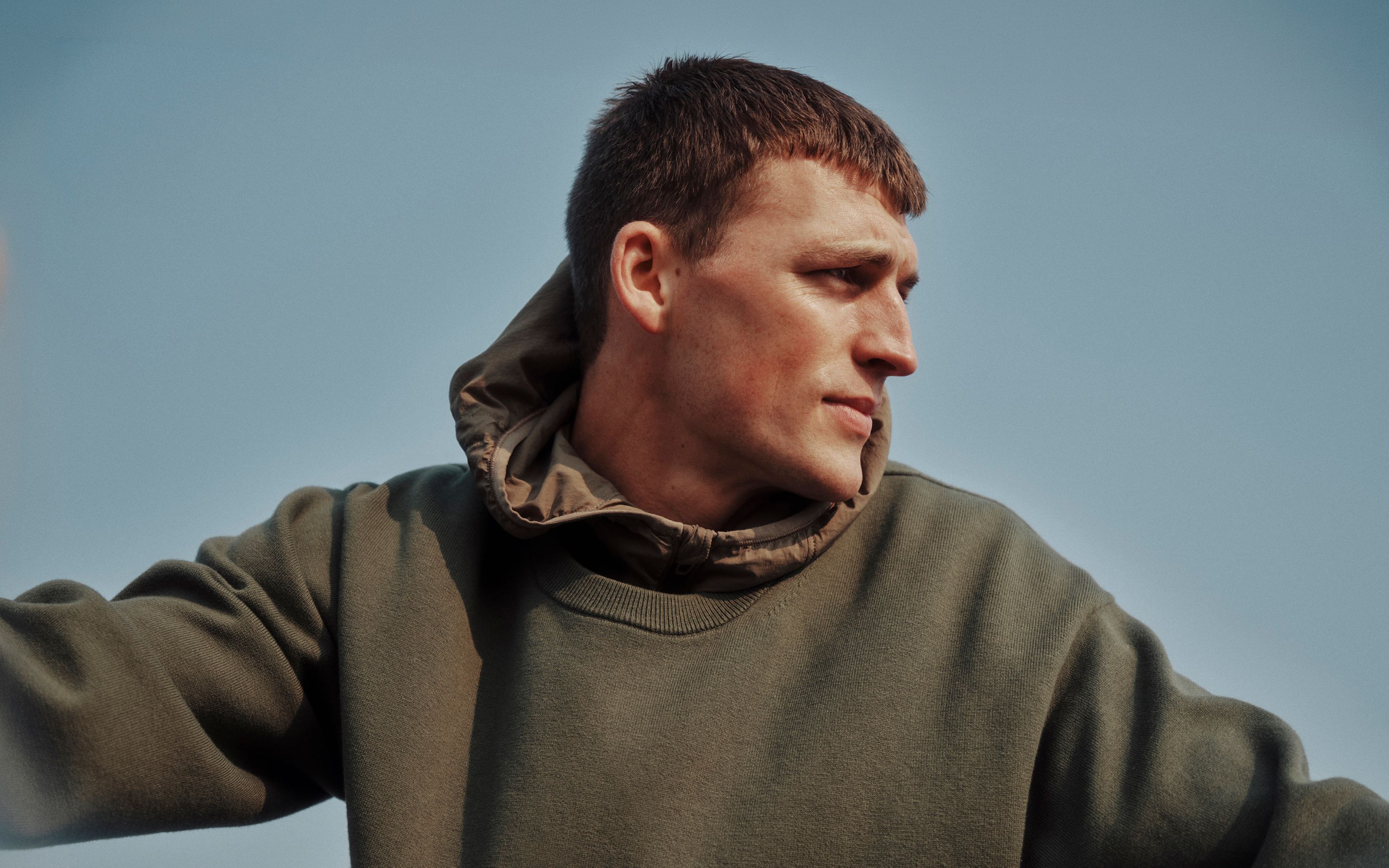 A person wears the Cotton-Blend Knit Long-Sleeve Crewneck.