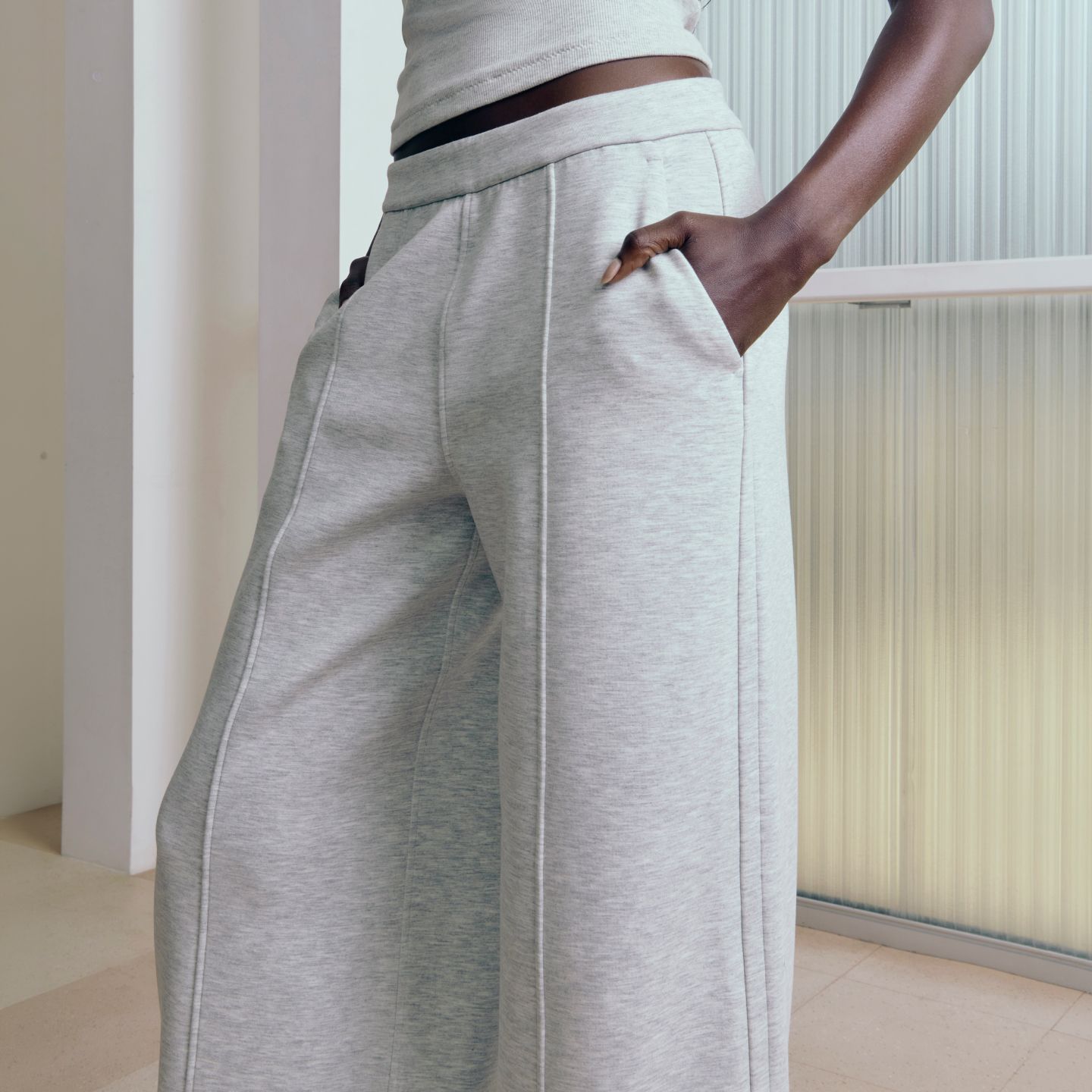 A person rests their hands in the pockets of the Smooth Spacer Wide-Leg Pant.