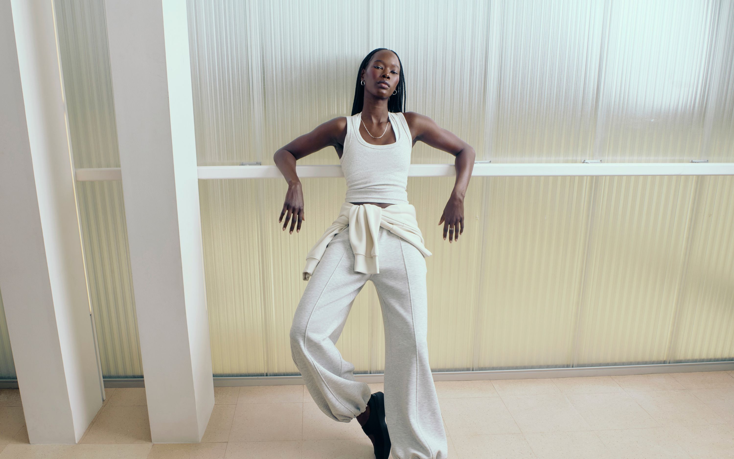 A person leans against a railing while wearing the Smooth Spacer Wide-Leg Pant.