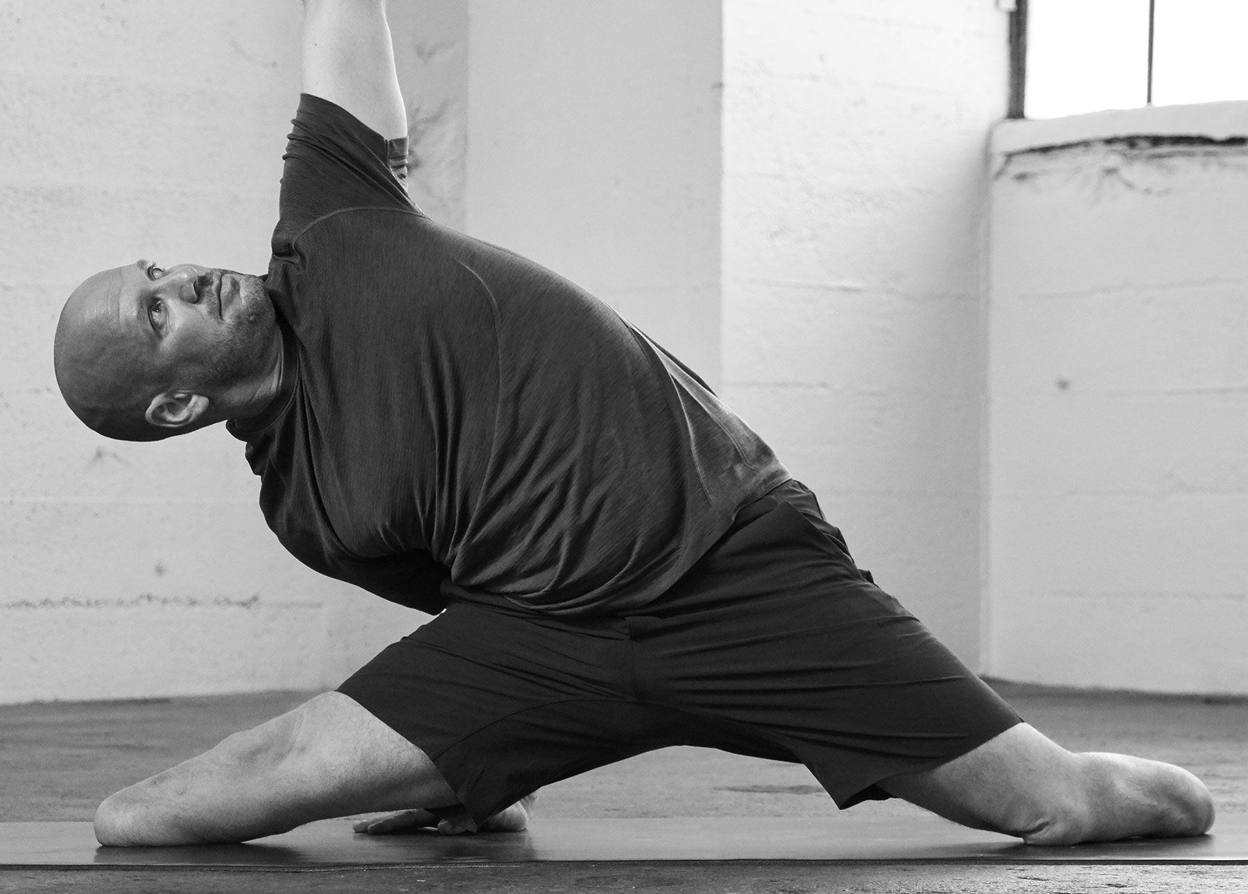 Two men stretching together.