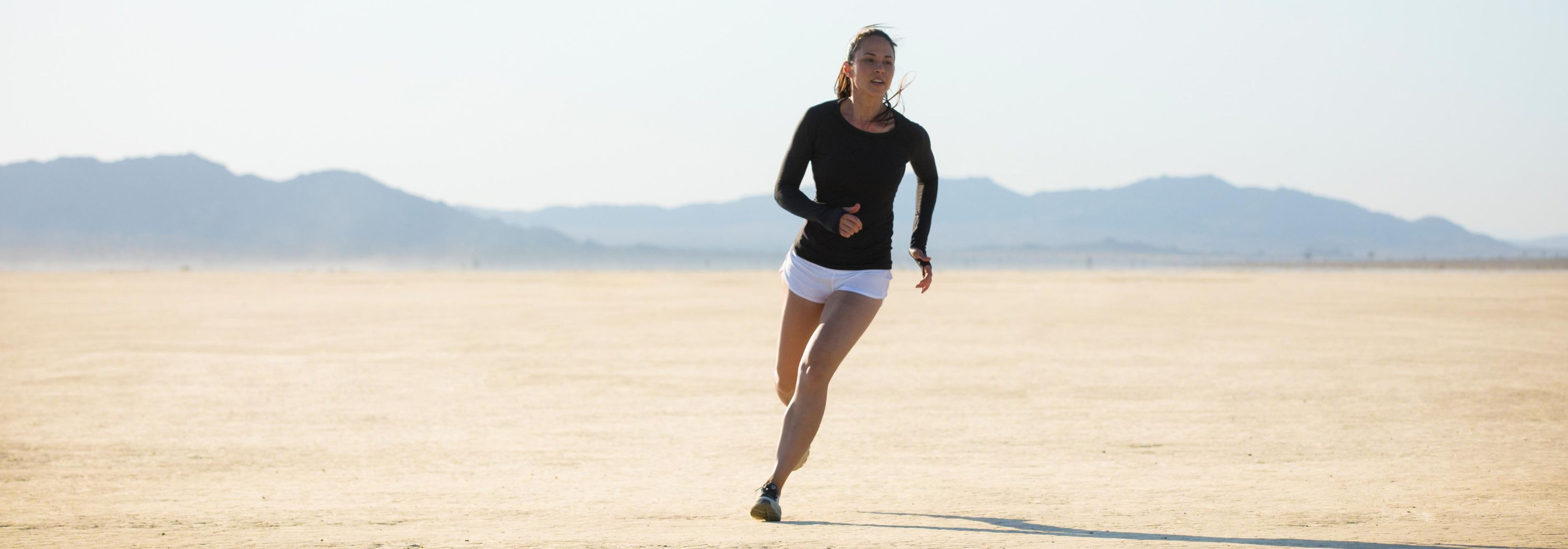 Woman running in desert.