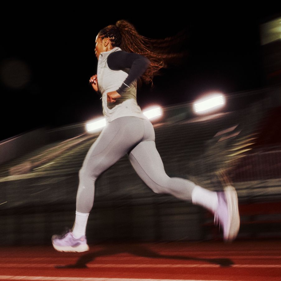 A blurred woman running in lululemon running gear.