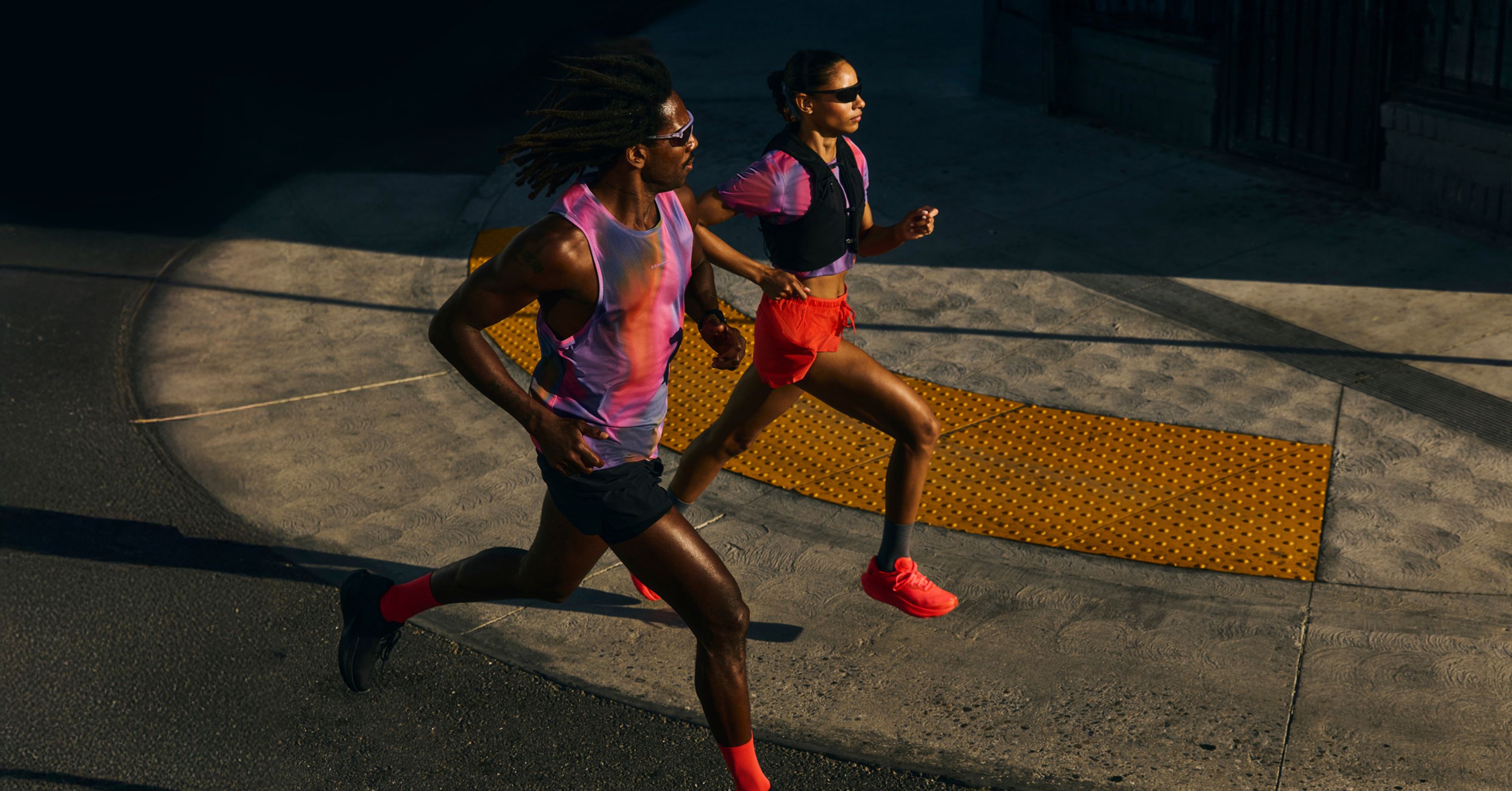 Two people dressed in lululemon Fast and Free in Speed Glow Multi Running in the street