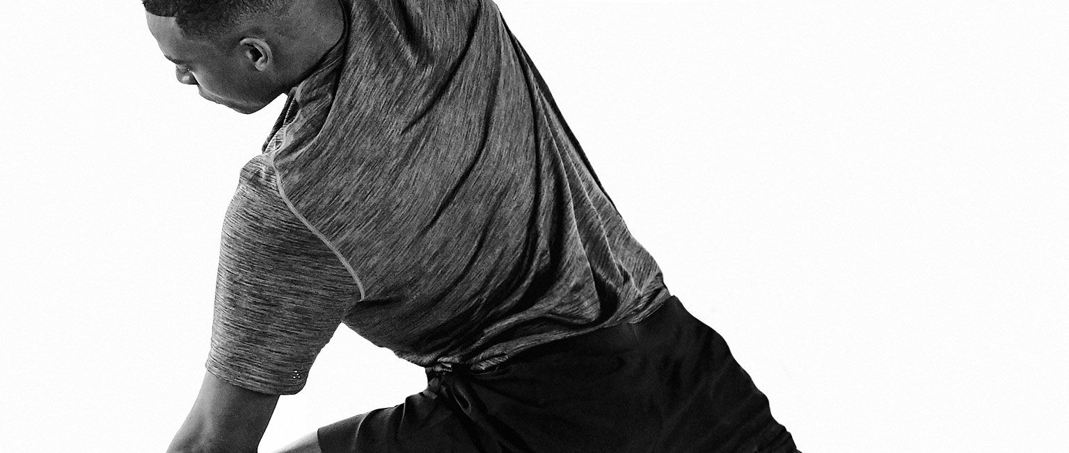 Male student practicing yoga 